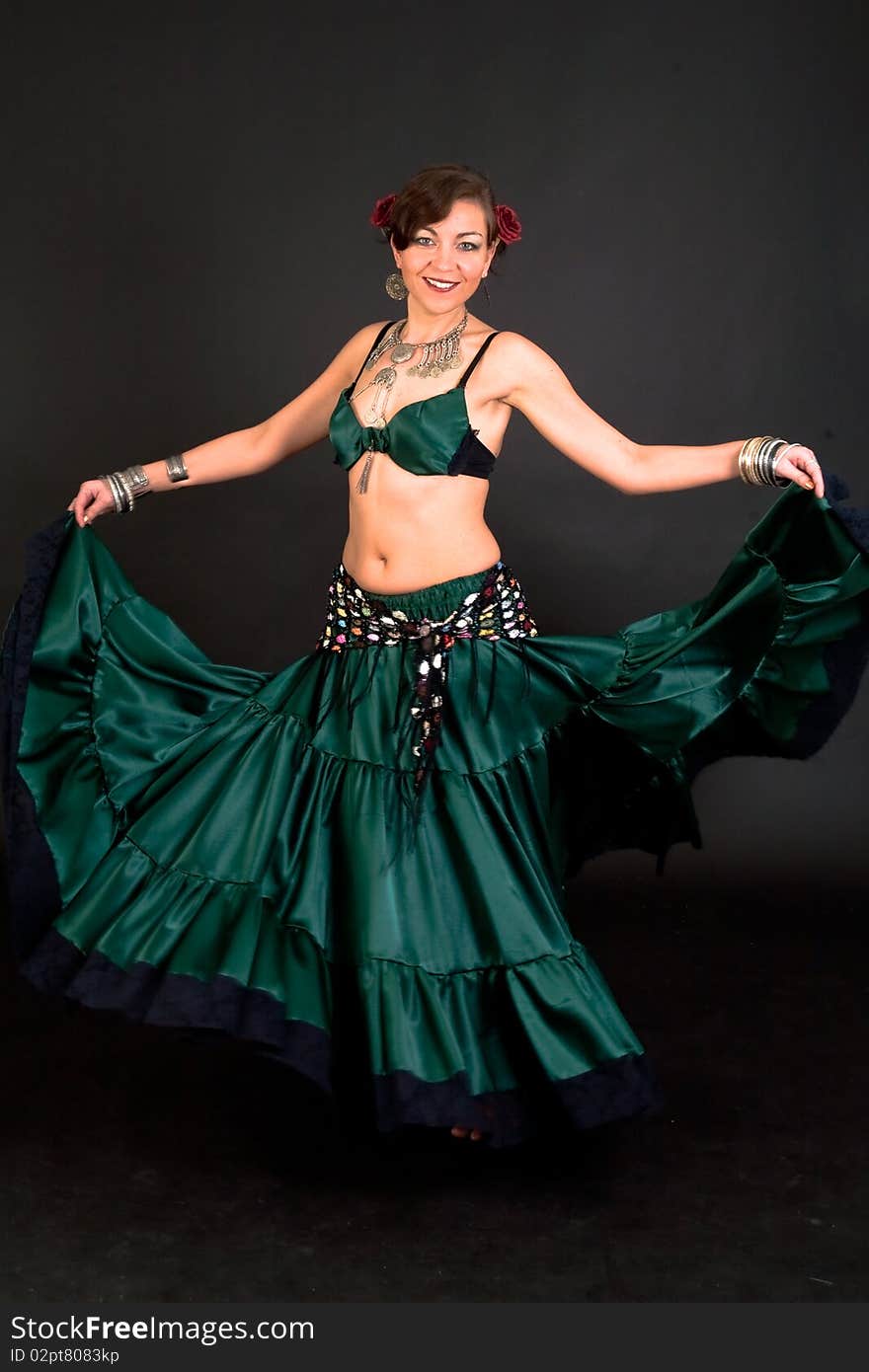 Beautiful belly dancer woman in front of black background