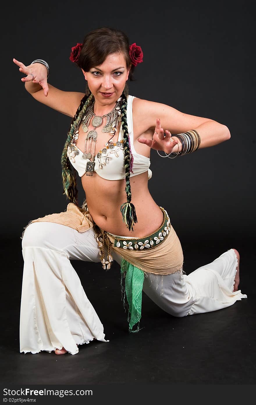 Beautiful belly dancer woman in front of black background