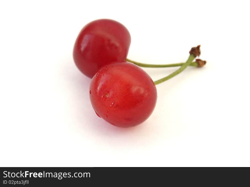 Two ripe cherries isolated on white background