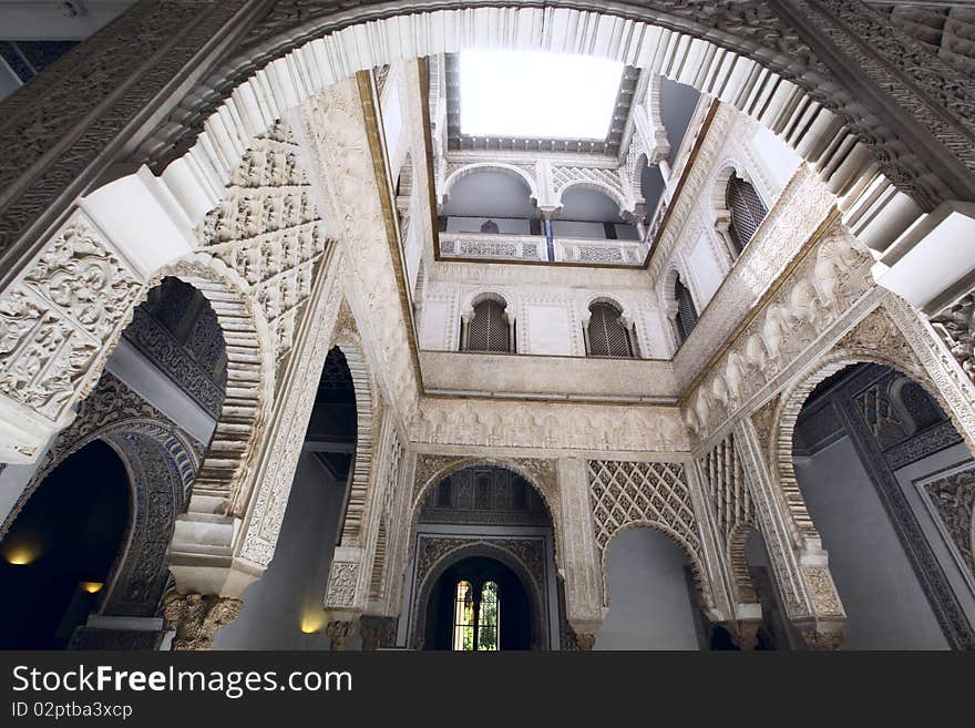 Arches and pillars in Alcázar of Seville, Spain.