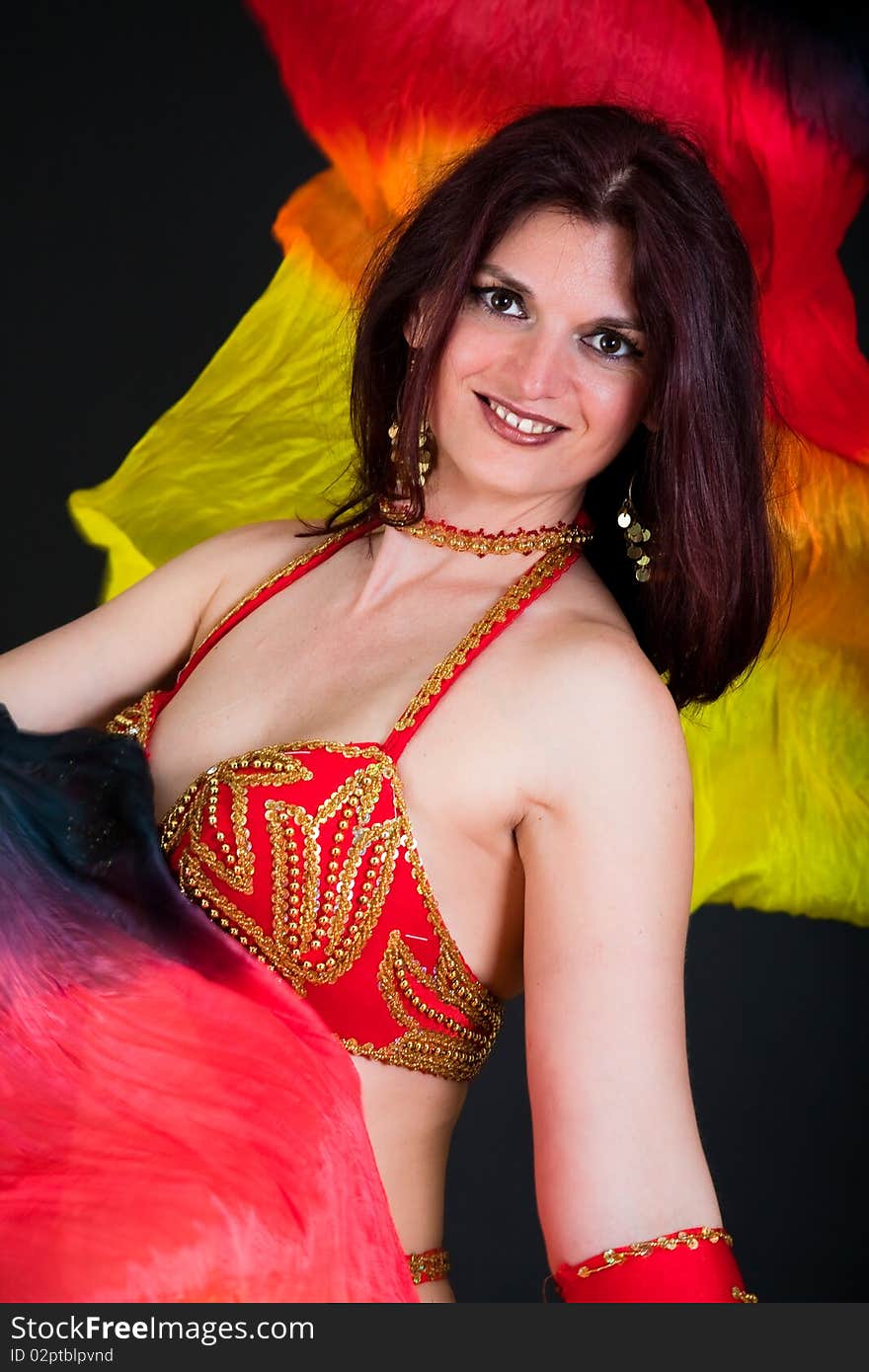 Beautiful belly dancer woman in front of black background