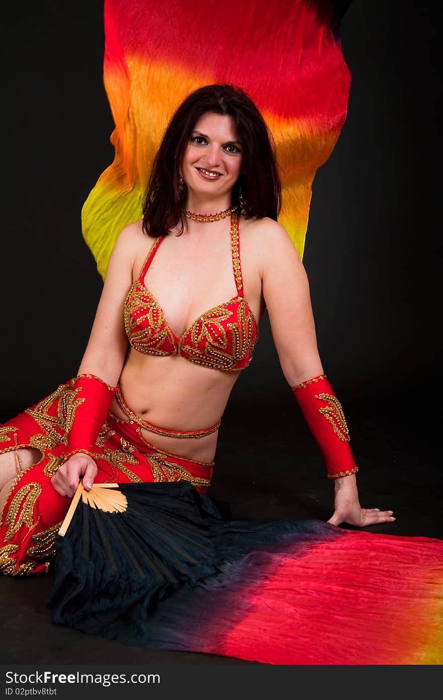 Beautiful belly dancer woman in front of black background