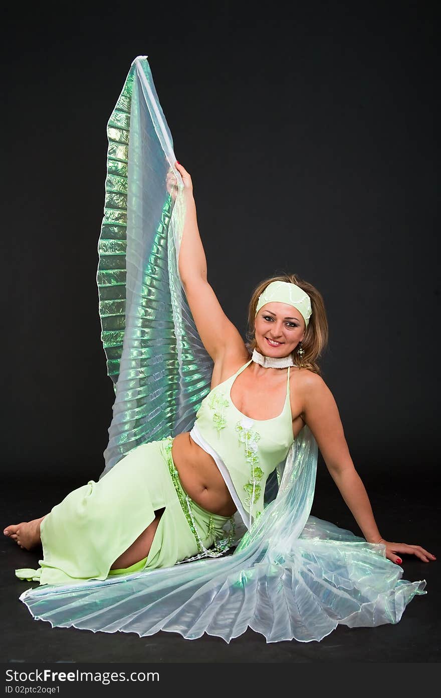 Beautiful belly dancer woman in front of black background