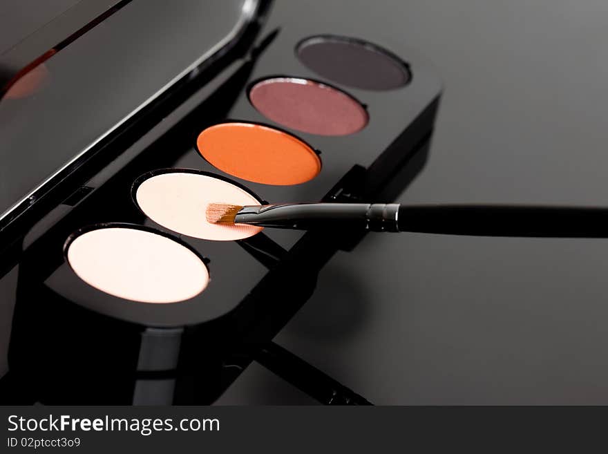 Make-up eyeshadows and cosmetic brush