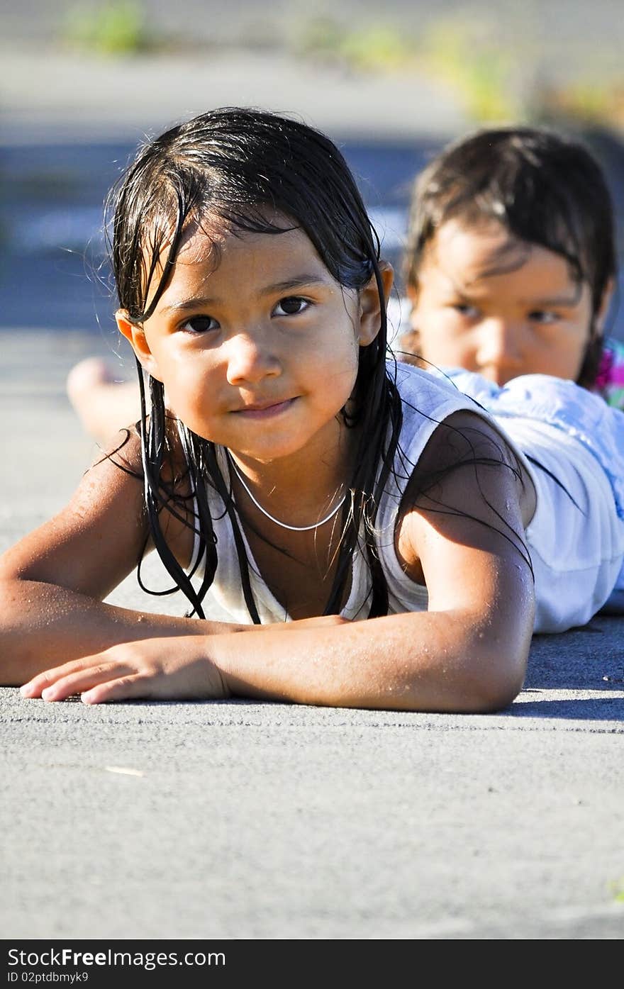 Two Girls Resting On The Ground