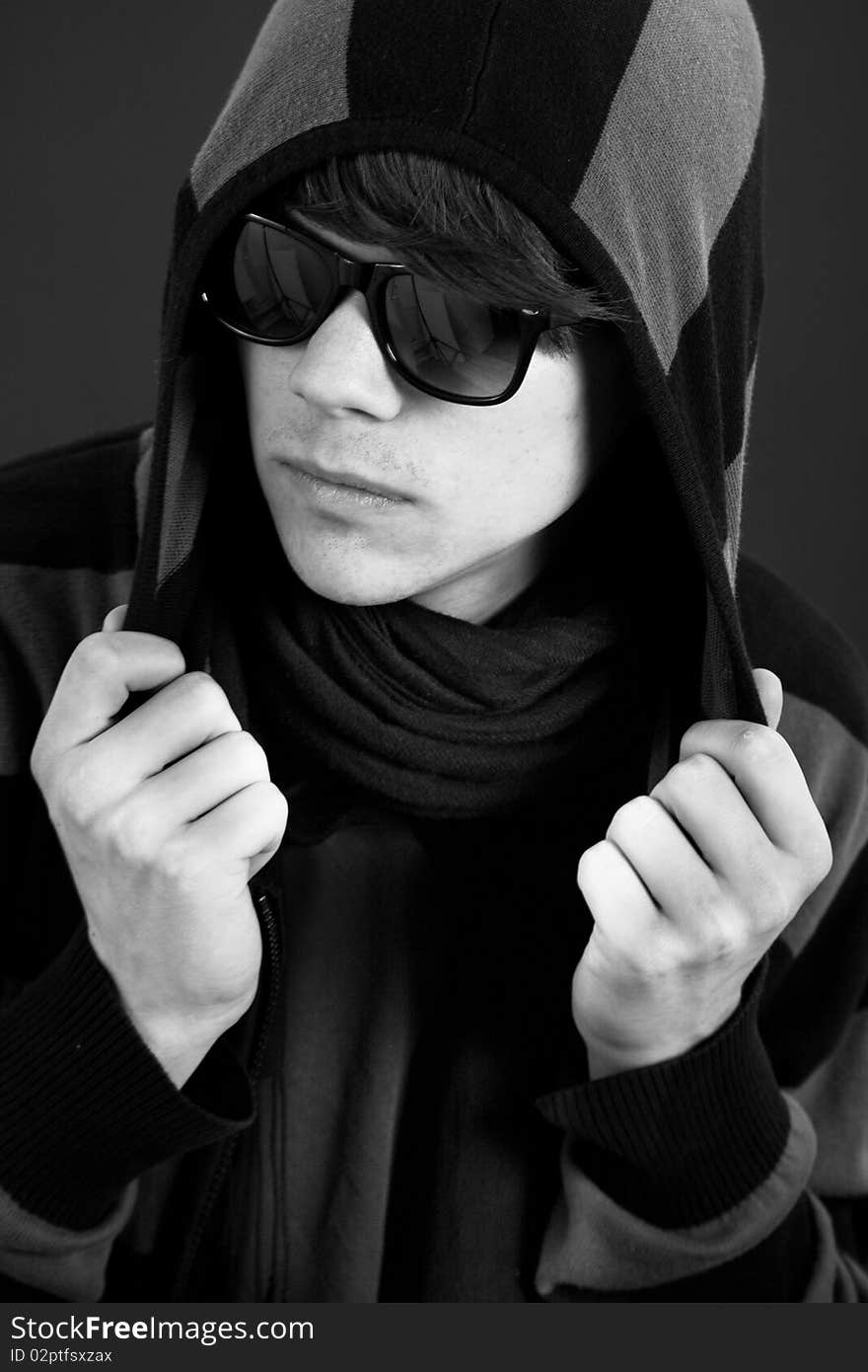 Black & white portrait of cool teen male holding his hoodie. Black & white portrait of cool teen male holding his hoodie