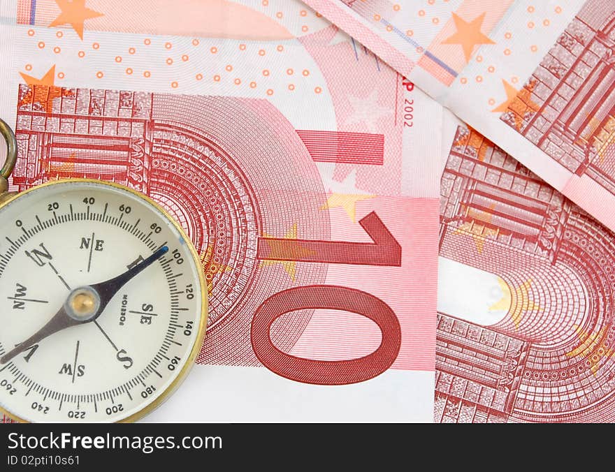 Compass on top of ten Euro banknotes. Compass on top of ten Euro banknotes