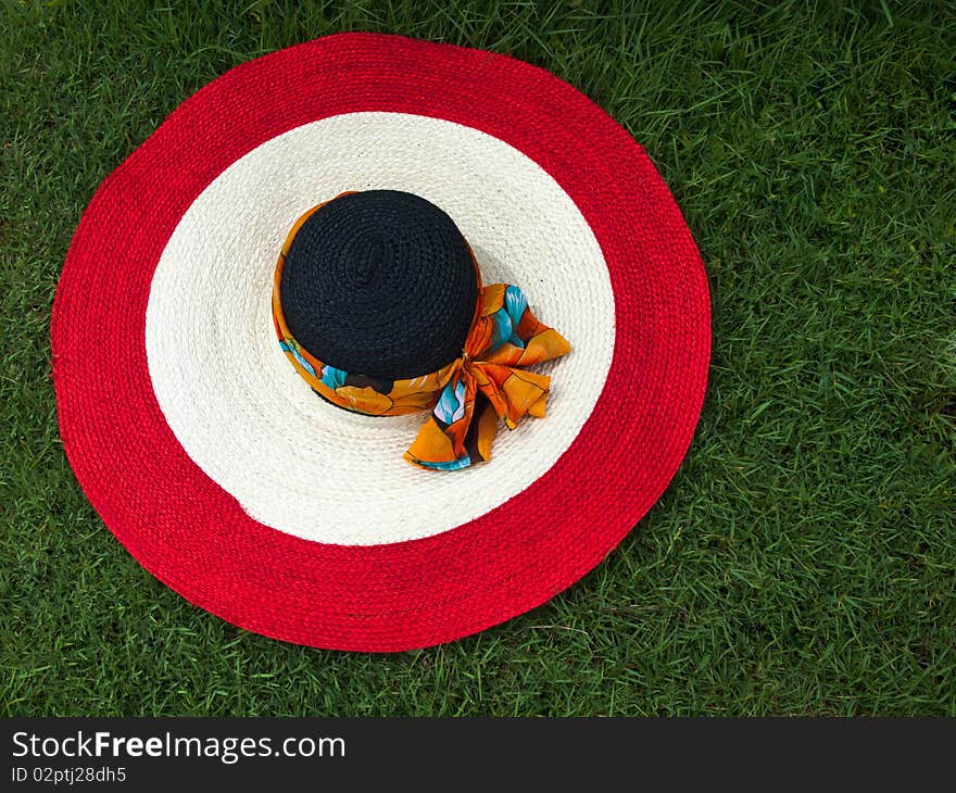 Red white and black big round straw hat. Red white and black big round straw hat