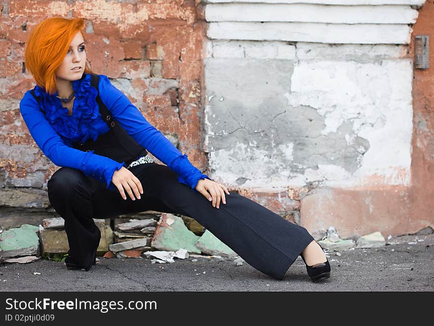 Beautiful woman near the wall