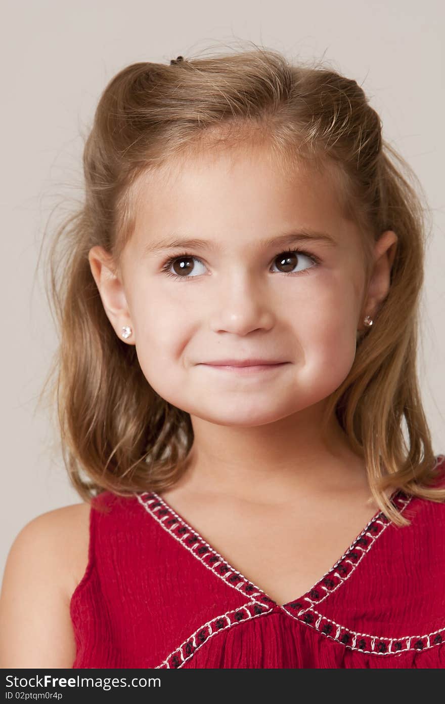 Portrait of pretty little 5 year old girl with blond hair and red dress. Portrait of pretty little 5 year old girl with blond hair and red dress.