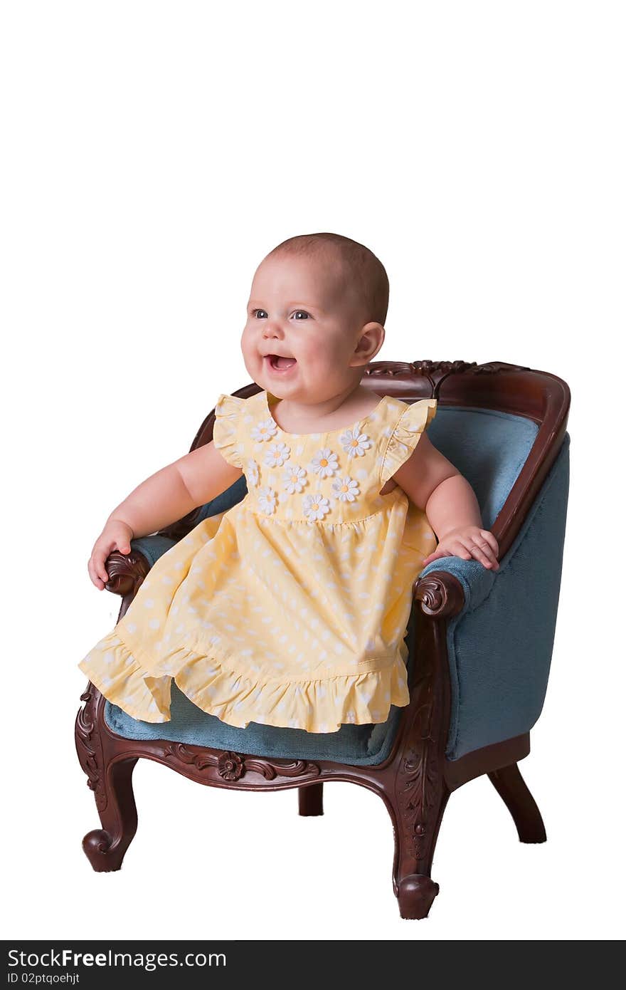 Cute baby wearing yellow dress sitting in chair on white background. Cute baby wearing yellow dress sitting in chair on white background