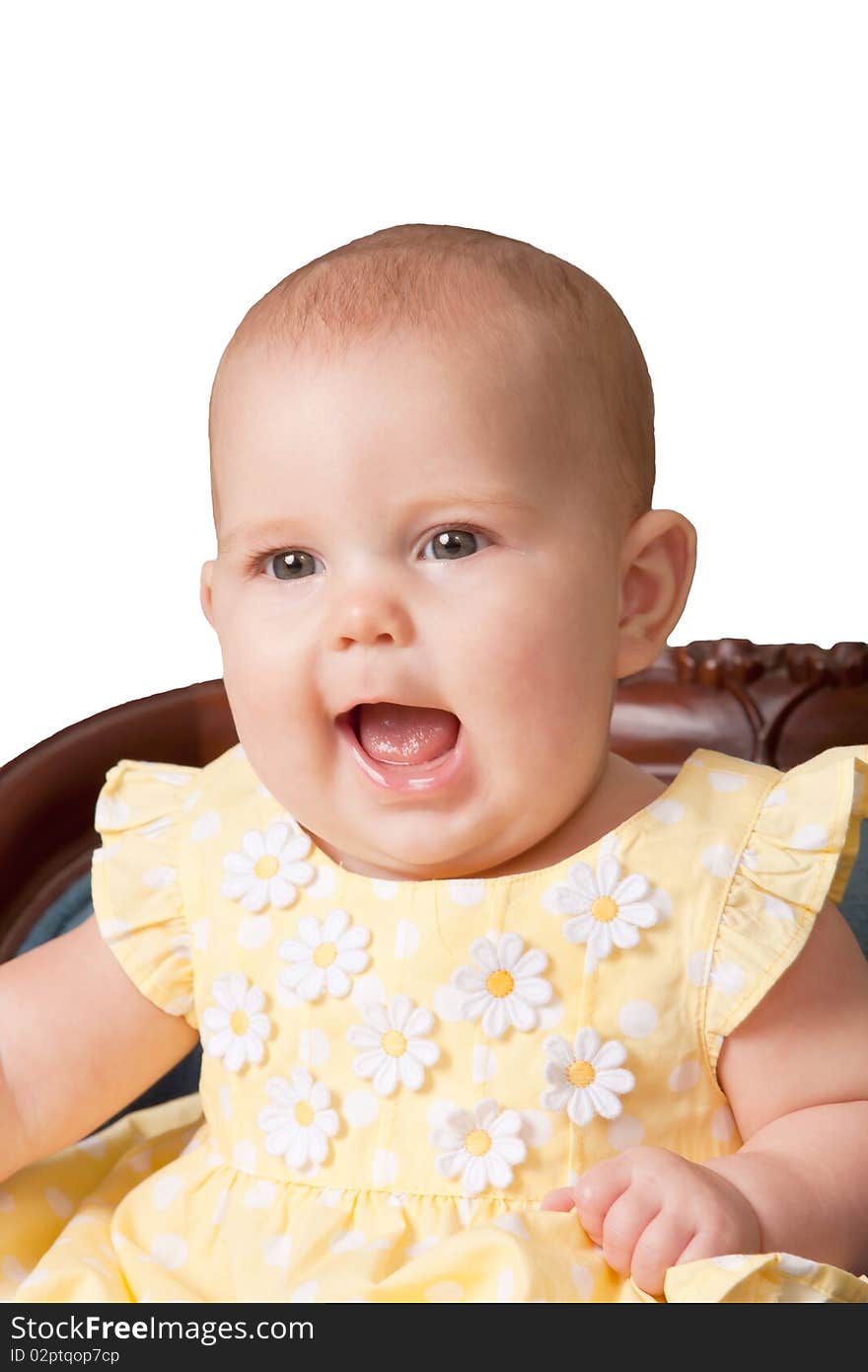 Cute baby wearing yellow dress sitting in chair on white background. Cute baby wearing yellow dress sitting in chair on white background