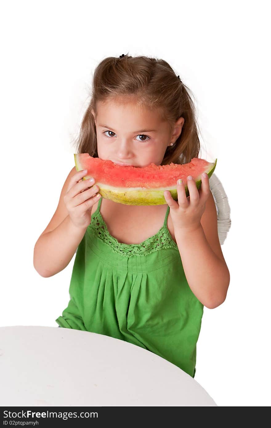 Pretty little 5 year old girl wearing a green dress and eating a watermelon. Pretty little 5 year old girl wearing a green dress and eating a watermelon.