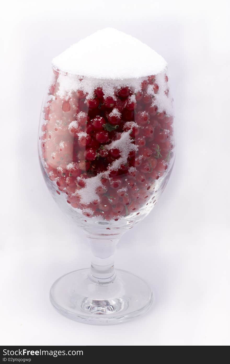 A cup full of tasty currants and sugar. A cup full of tasty currants and sugar