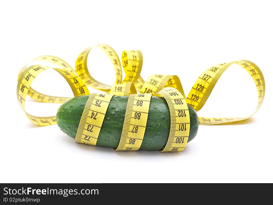 Cucumber with a measuring tape on white