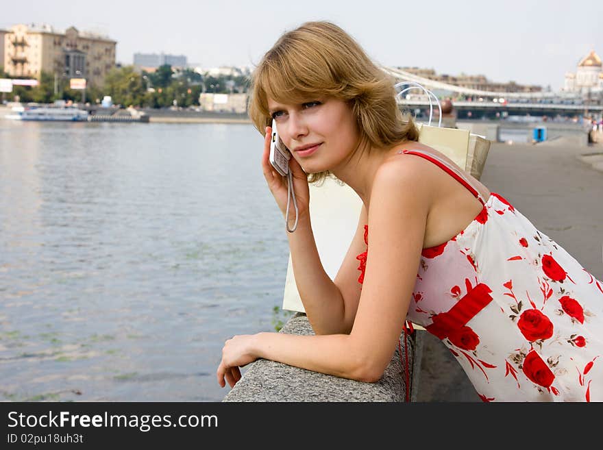 Woman Is Talking Mobile Phone Outdoors.