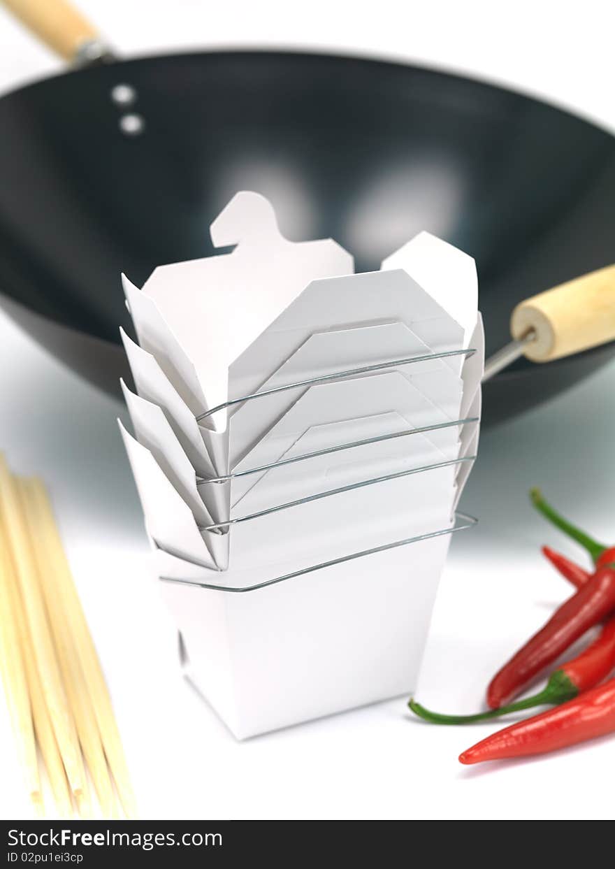 A Chinese takeaway container and a wok isolated against a white background