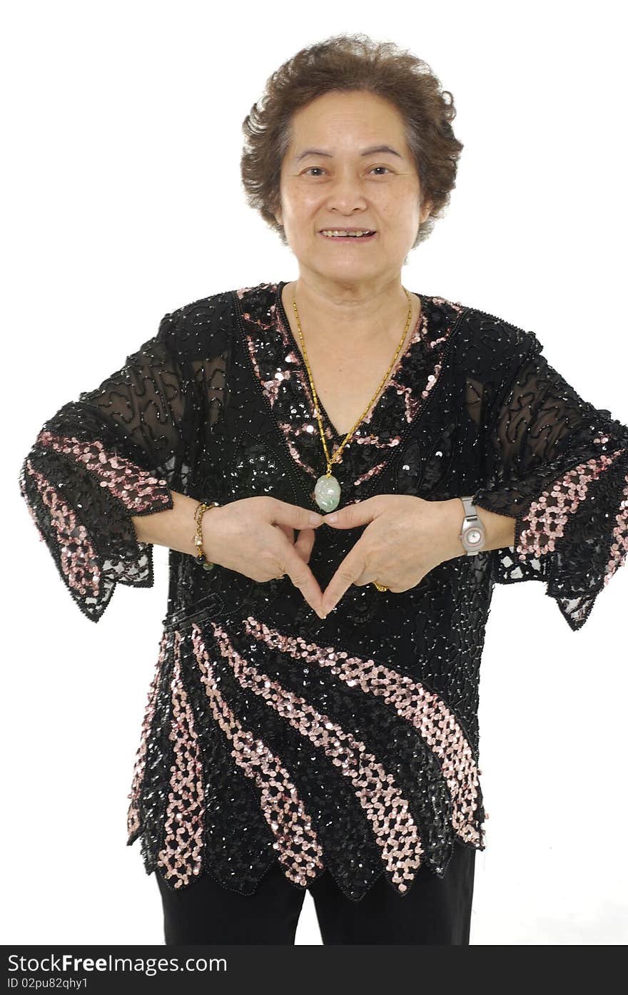 Portrait Of Senior woman making a heart gesture