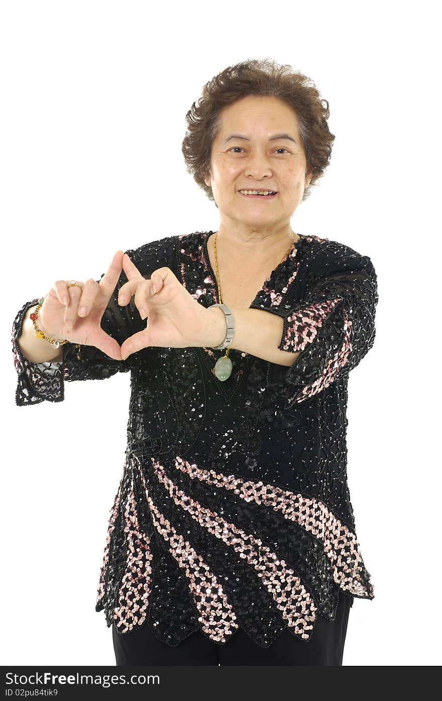 Portrait Of Senior woman making a heart gesture