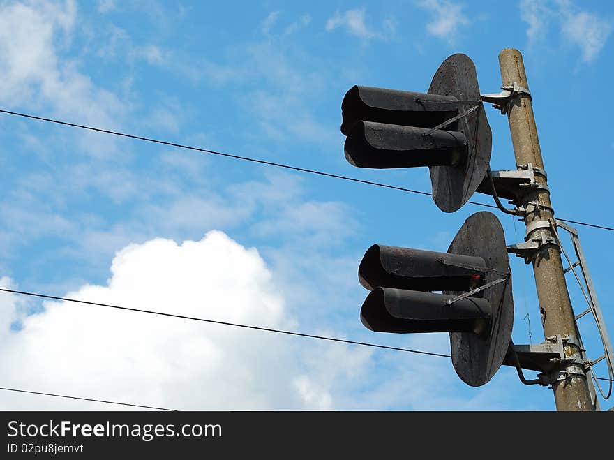 Railway traffic lights at blue sky background