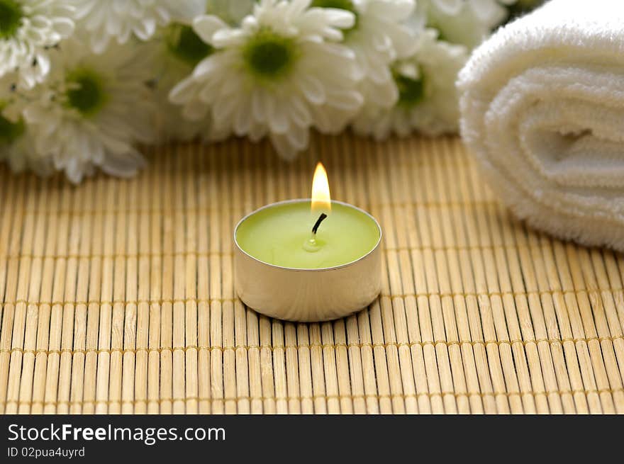 Spa composition. Towel, candle and flowers. Spa composition. Towel, candle and flowers.