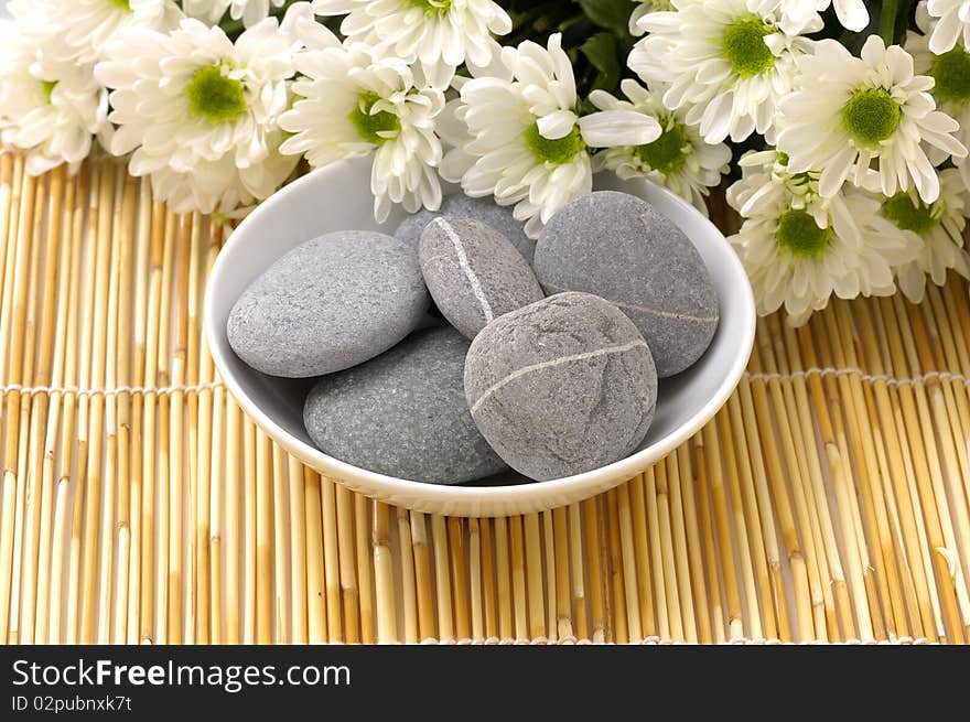 Bowl of pebbles with Chrysanthemums flowers. Bowl of pebbles with Chrysanthemums flowers