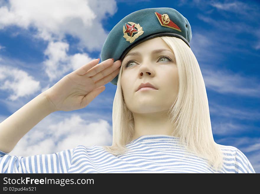 Woman in shape holds a hand near a headdress against the dark blue sky with clouds. Woman in shape holds a hand near a headdress against the dark blue sky with clouds