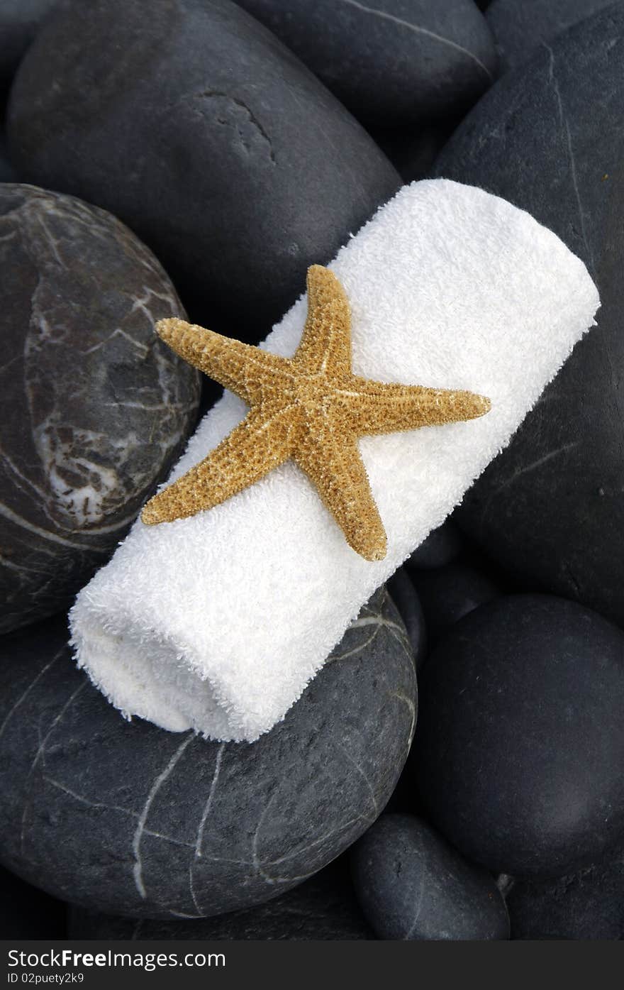 Time to relax- stones, and candle, starfish. Time to relax- stones, and candle, starfish