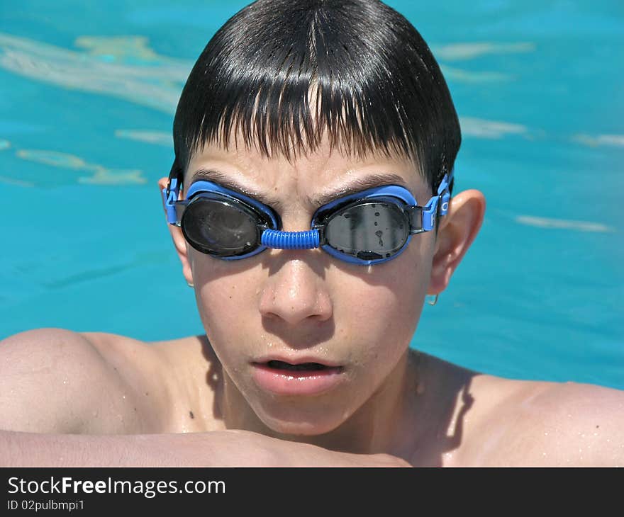 Boy having a rest after long swimming in the pool. Boy having a rest after long swimming in the pool.