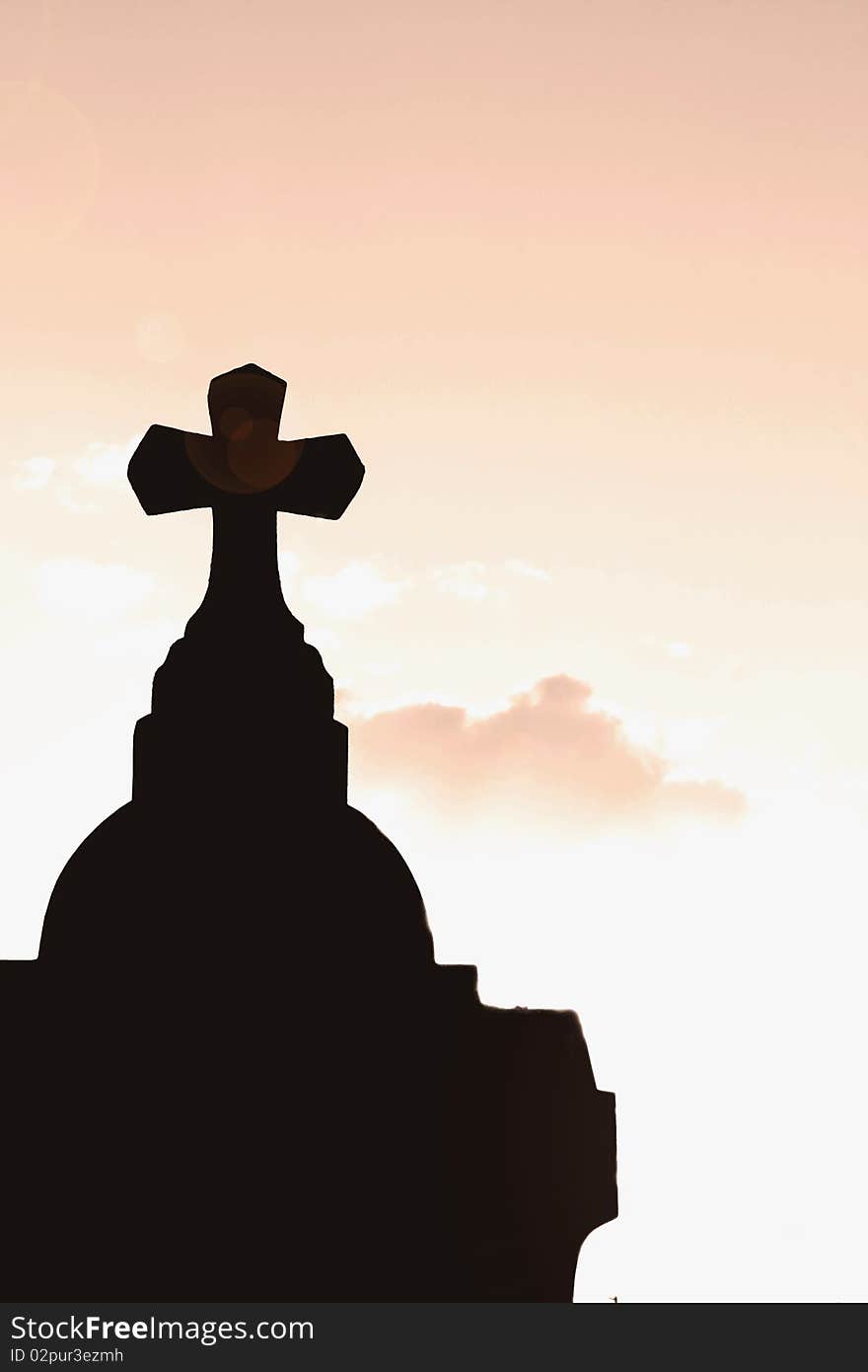 Silhouette of a cross in beams of light