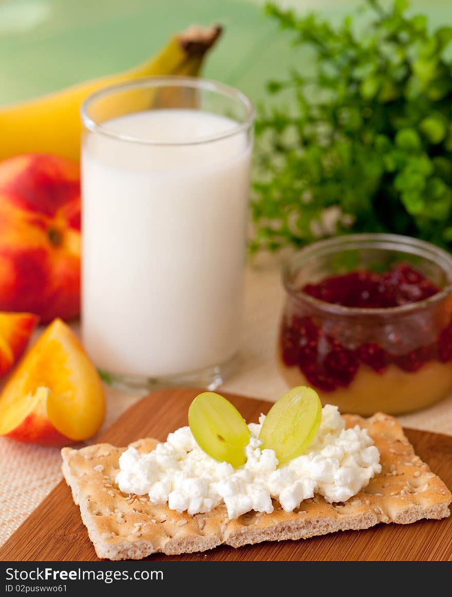 Breakfast with milk and fruits and crispbread on a table