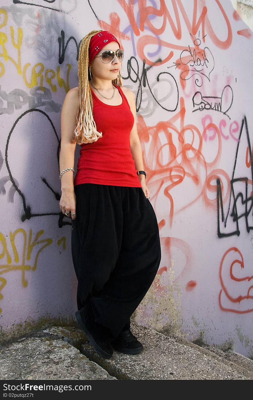 Hip-hop styled girl in red posing