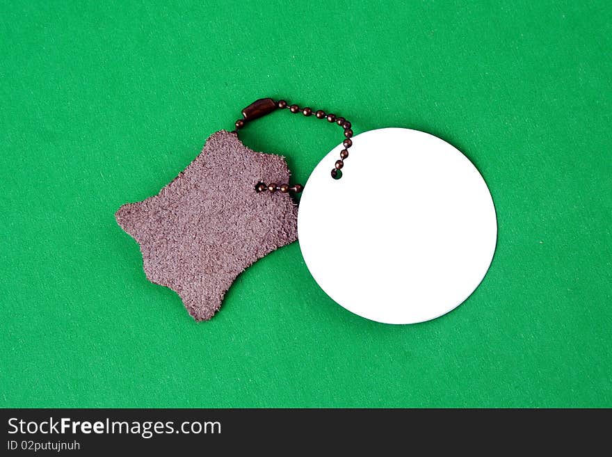 Black empty tag with a green cord isolated on a white background