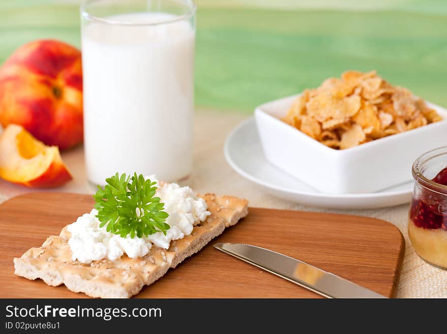 Crispbread, fruits, cornflakes and milk on a table. Crispbread, fruits, cornflakes and milk on a table