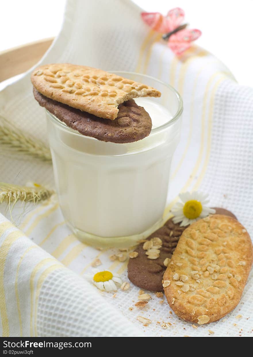 Glass of milk and cookies on light kitchen towel. Glass of milk and cookies on light kitchen towel