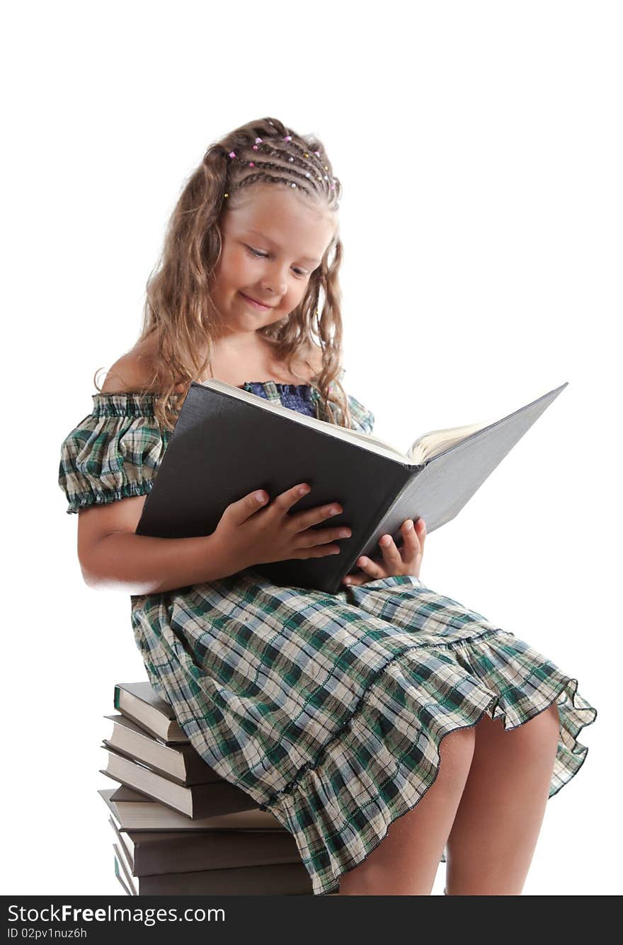 Little girl with pigtails reading a book