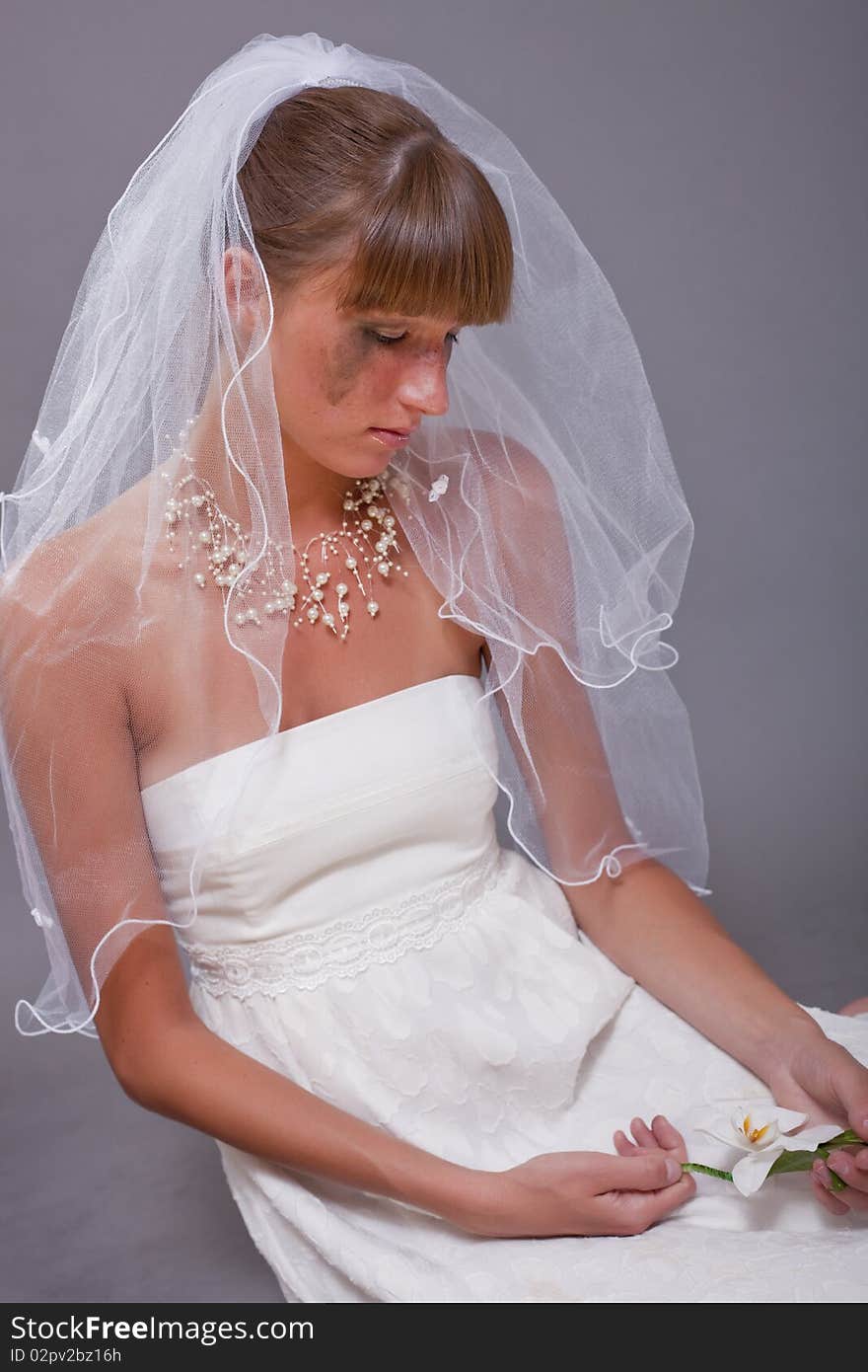 Disappointed and crying bride sitting on the ground