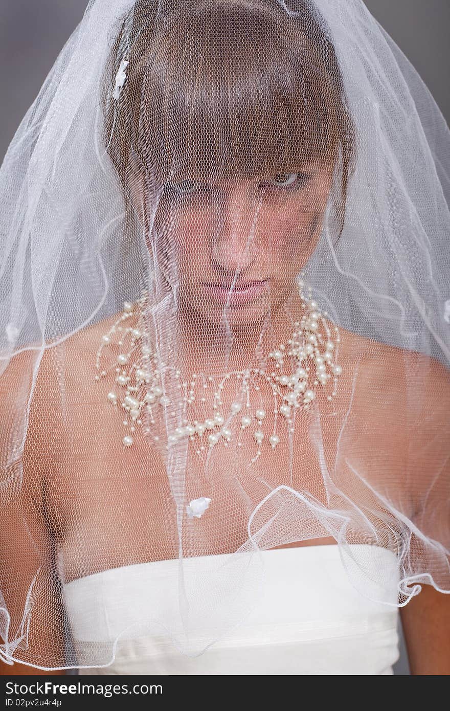 Portrait of sad bride under long white veil. Portrait of sad bride under long white veil