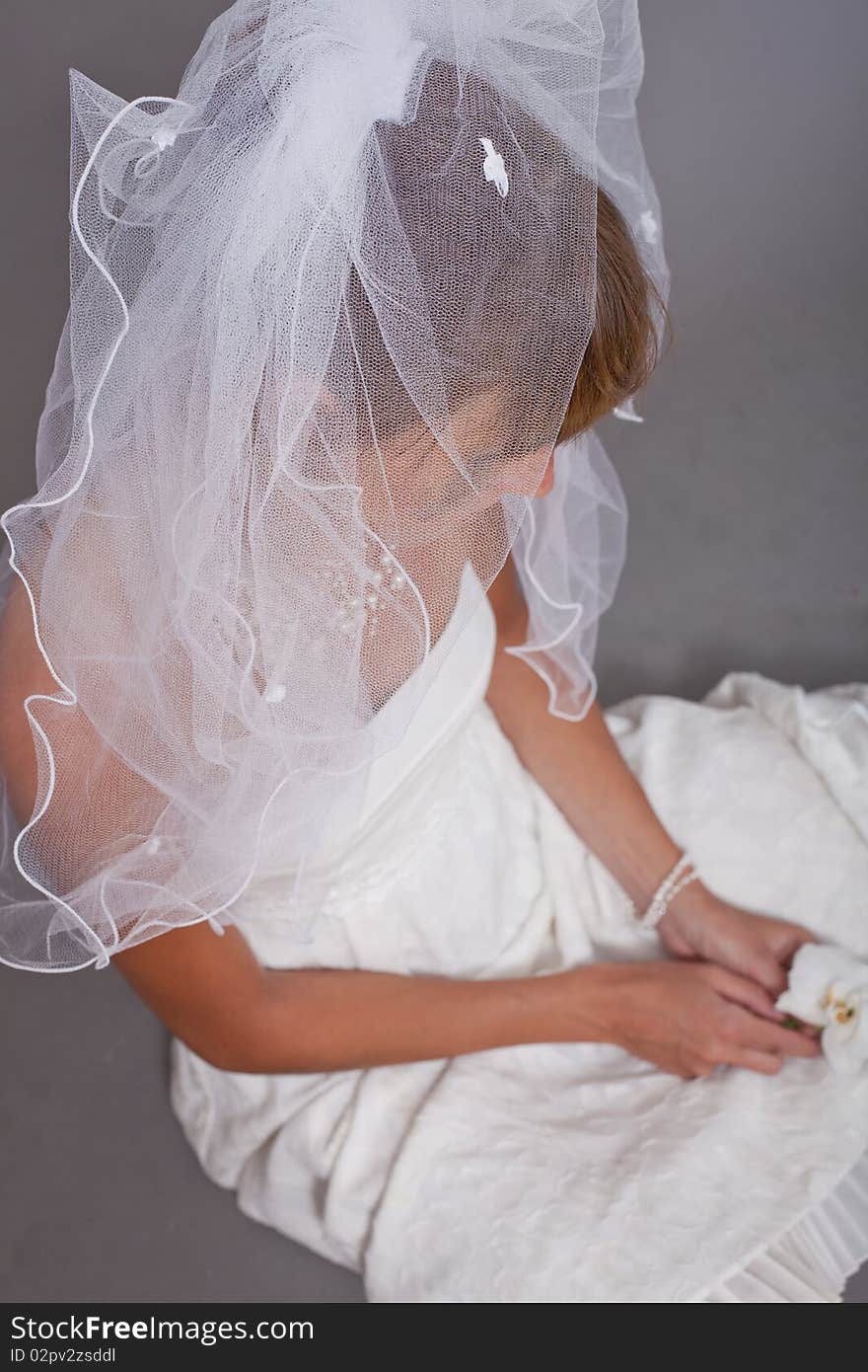 Young frustrated bride sitting on the ground. Young frustrated bride sitting on the ground