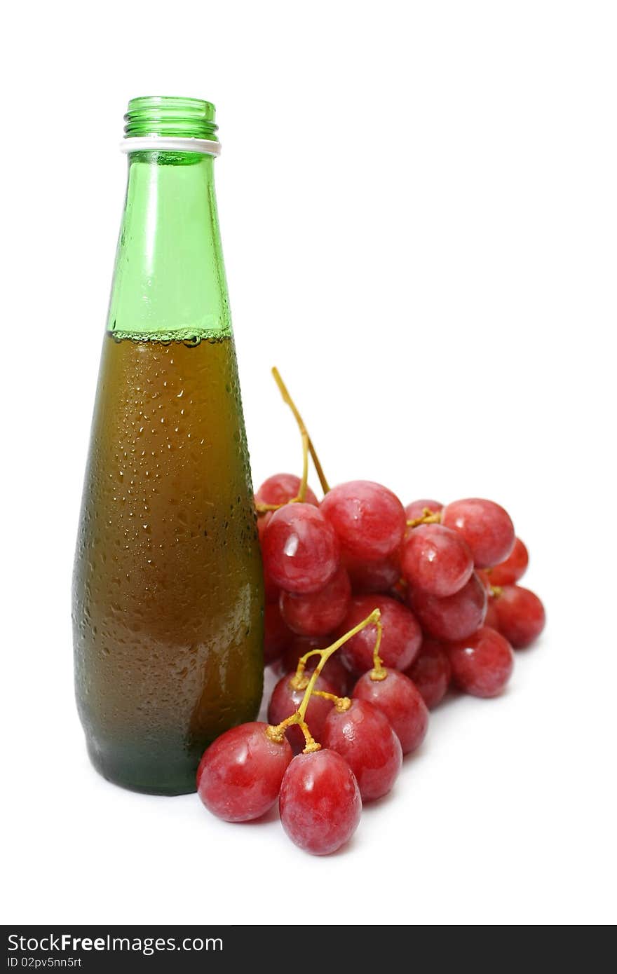 A string of red grapes beside wine bottle. A string of red grapes beside wine bottle.