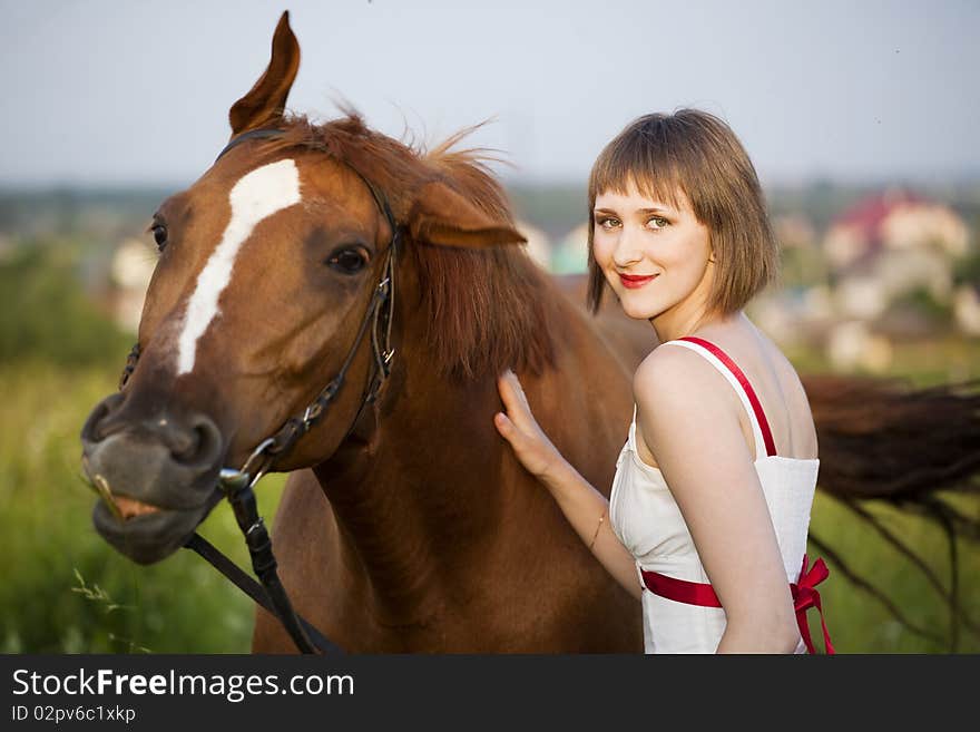 Young woman with horse in the field. Young woman with horse in the field