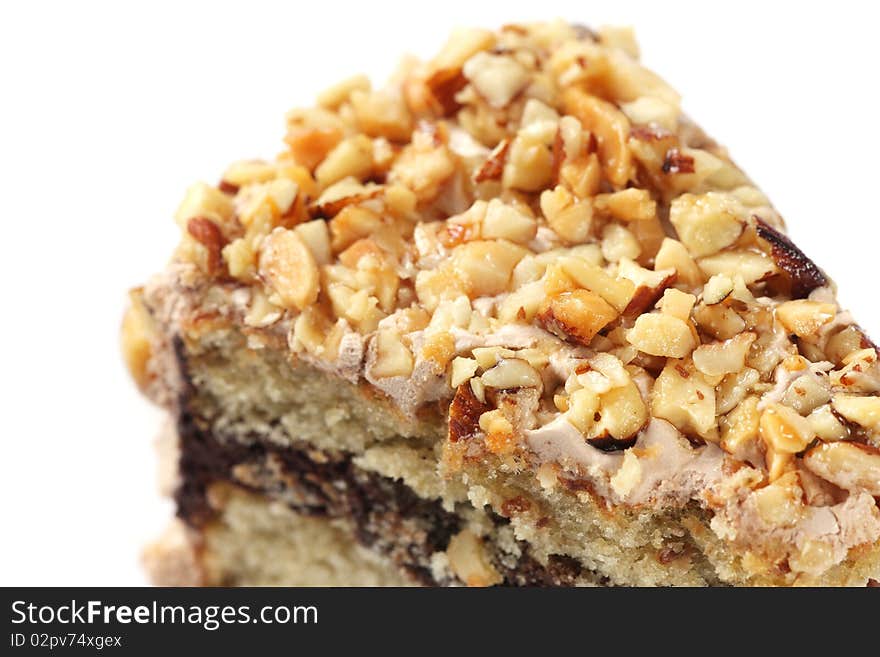 Slice of almond chocolate cake isolated over white background.