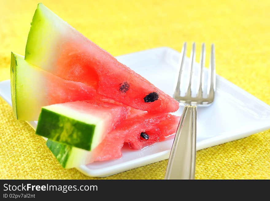 Fresh sliced watermelon in studio on yellow background
