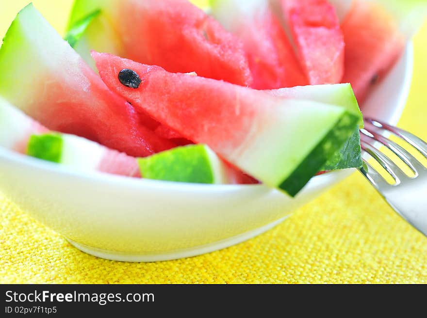 Fresh sliced watermelon in studio on yellow background