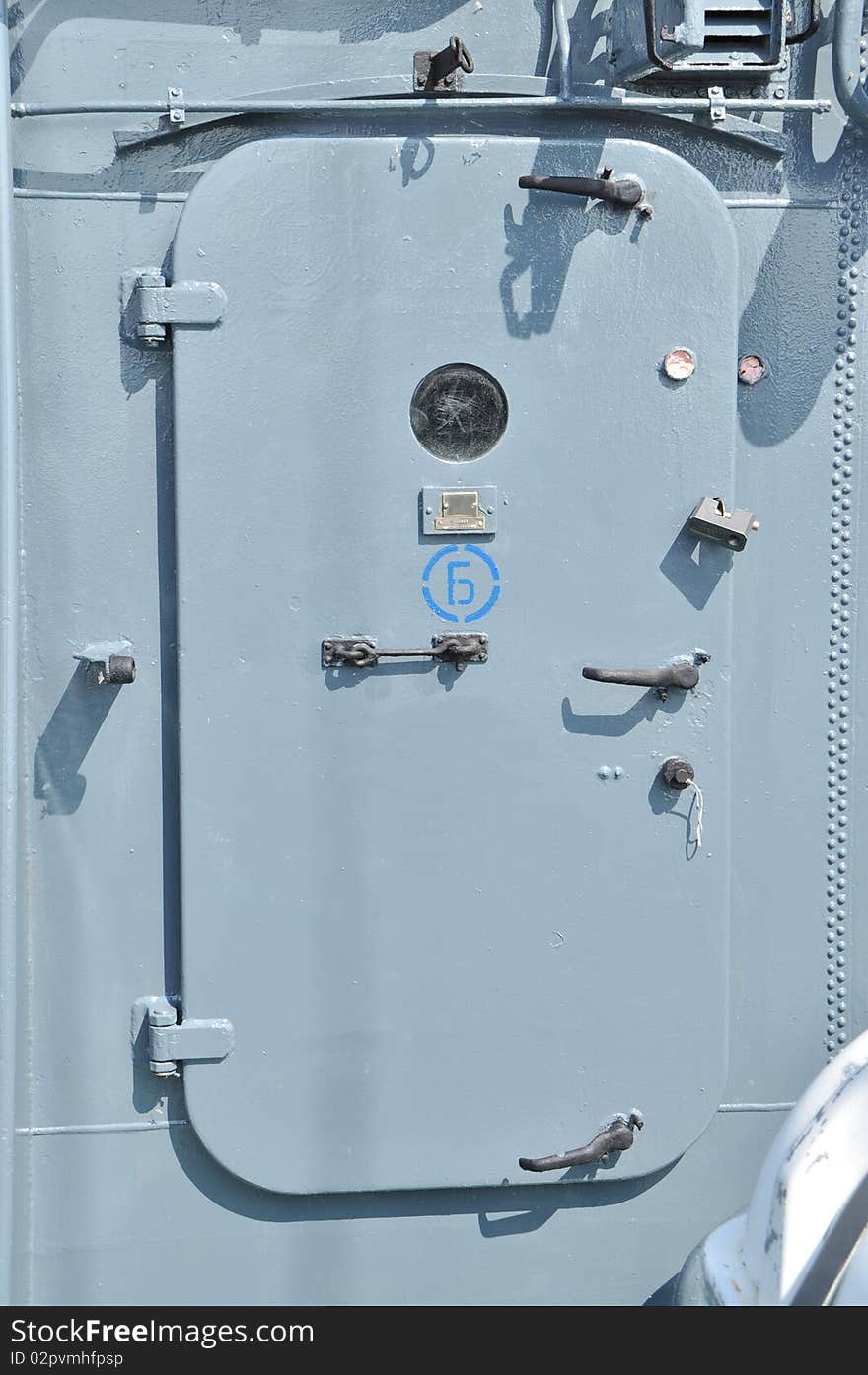 Metallic door of the marine ship with many hand locks