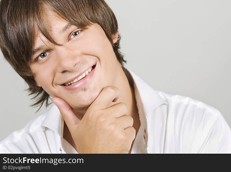 Closeup portrait of a charming young man smiling with copyspace. Closeup portrait of a charming young man smiling with copyspace