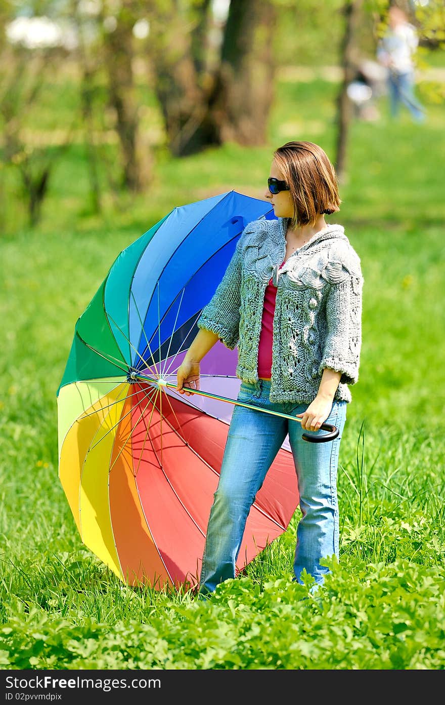 Beautiful woman with umbrella in rainbow colors