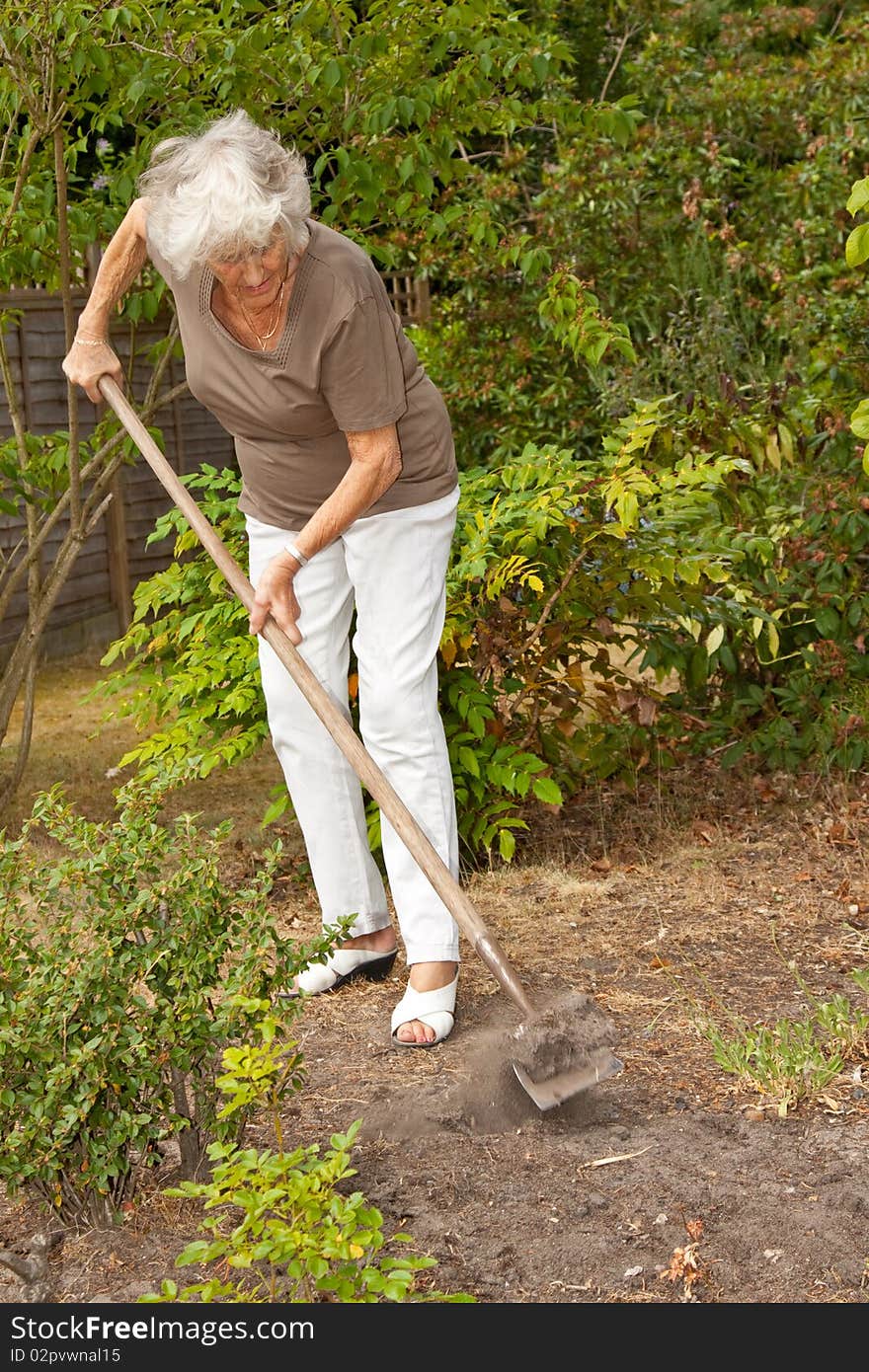 Senior lady gardener doing a little maintenance work. Senior lady gardener doing a little maintenance work