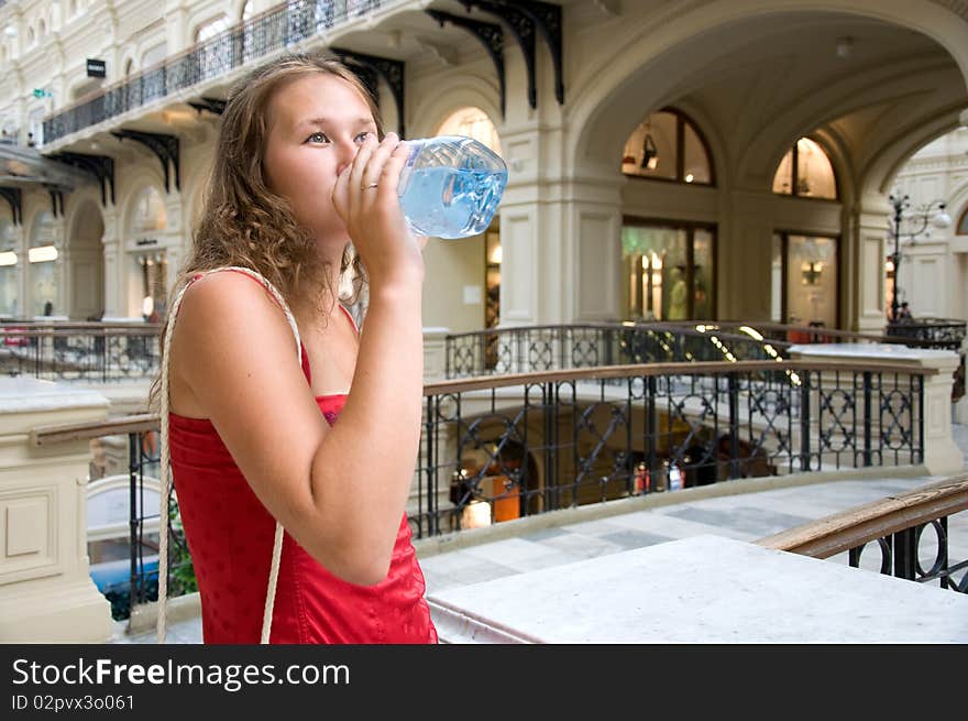 Adorable woman is quenching her thirst