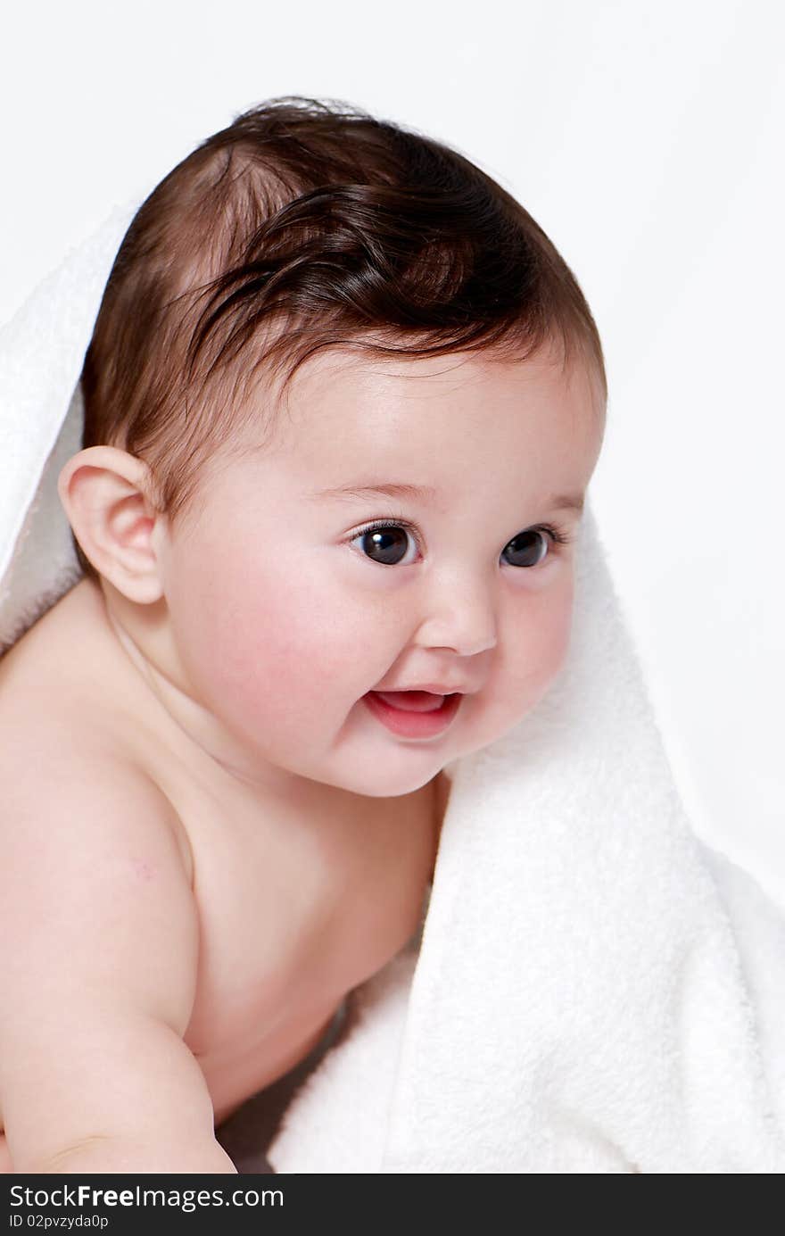 Portrait of the little baby under a terry towel